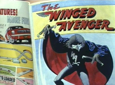 It’s a reference to an episode of The Avengers from 1967 entitled The Winged Avenger. Inspired by the then popularity of the Adam West Batman TV Series, it featured a murderer who dressed as the eponymous hawk-headed comic book villain and included illustrations by the veteran master comic artist Frank Bellamy.