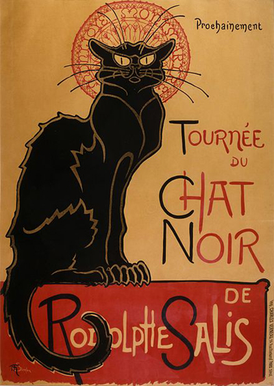 In the background, we can see the famous 1896 poster for a tour of the troup of performers of the Le Chat Noir cabaret by Théophile Steinlen. 